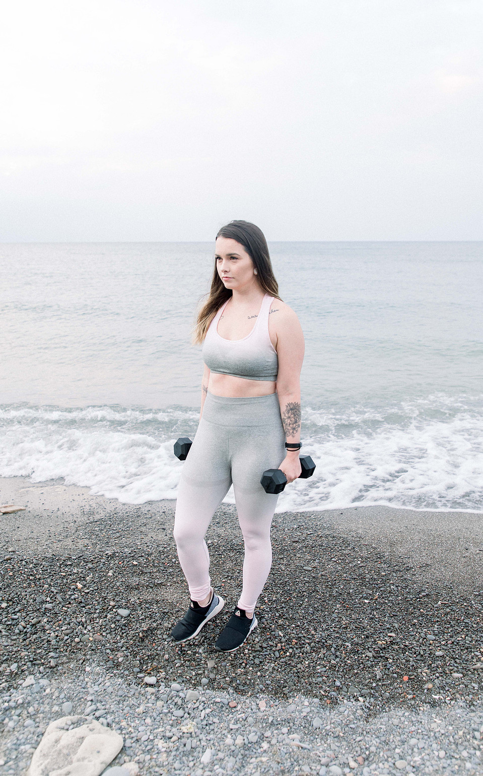 Portrait of a female fitness model holding dumbbells at her sides, Niagara portrait photographer, Niagara branding photographer