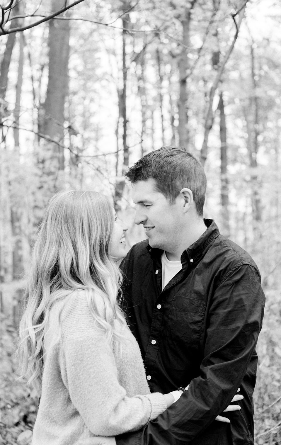 Black and white portrait of couple hugging each other and looking at each other, smiling. Niagara portrait photography, Niagara portrait photographer, Niagara family photography, Niagara family photographer.