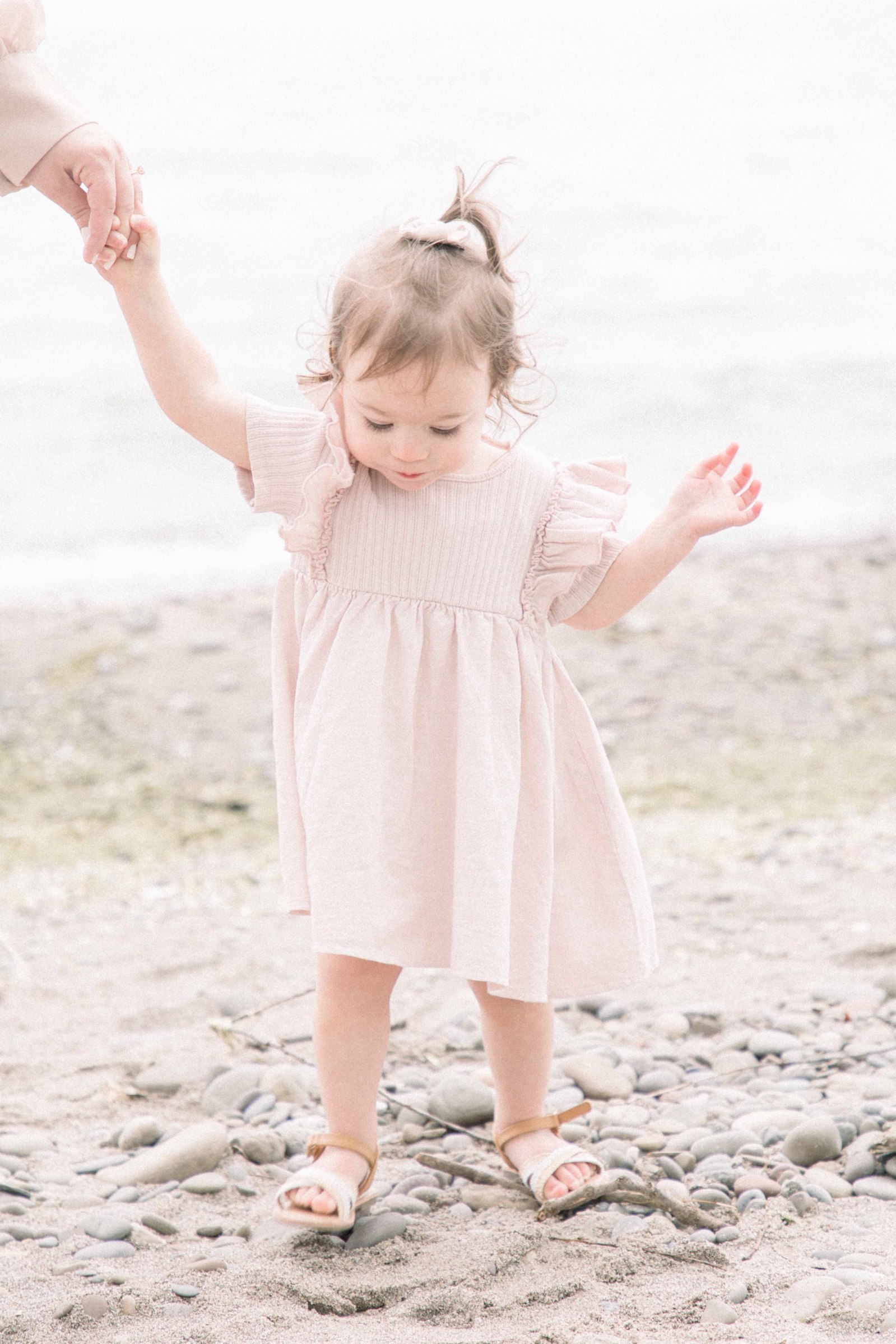 Portrait little girl holding her mother's hand on the beach, Niagara Portrait Photographer, Niagara Family Photographer, Niagara Motherhood Photography, Beach Portrait Photography, Emily VanderBeek Photography.