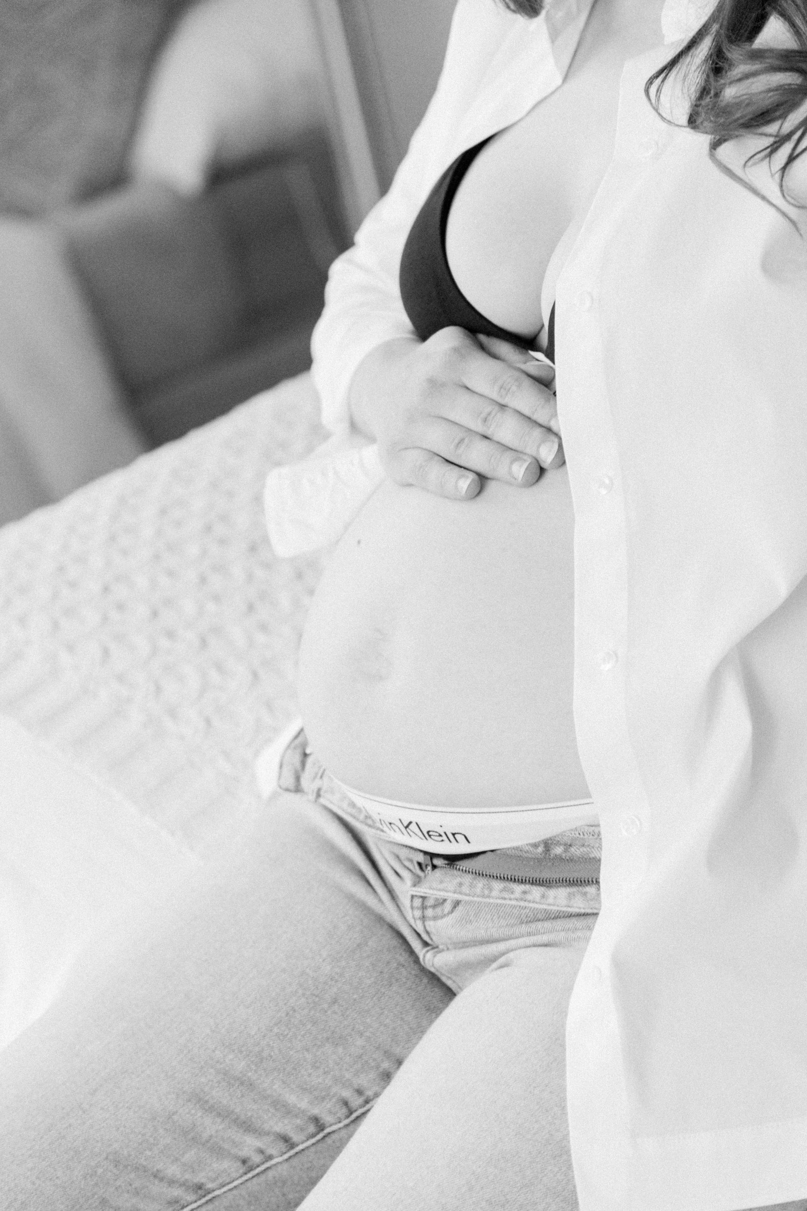 Black & white close up portrait of mom holding her pregnant belly. Portrait photography, family photography, motherhood photography, Niagara photographer, Niagara family photography, Vankleek Hill family photography. Emily VanderBeek Photo