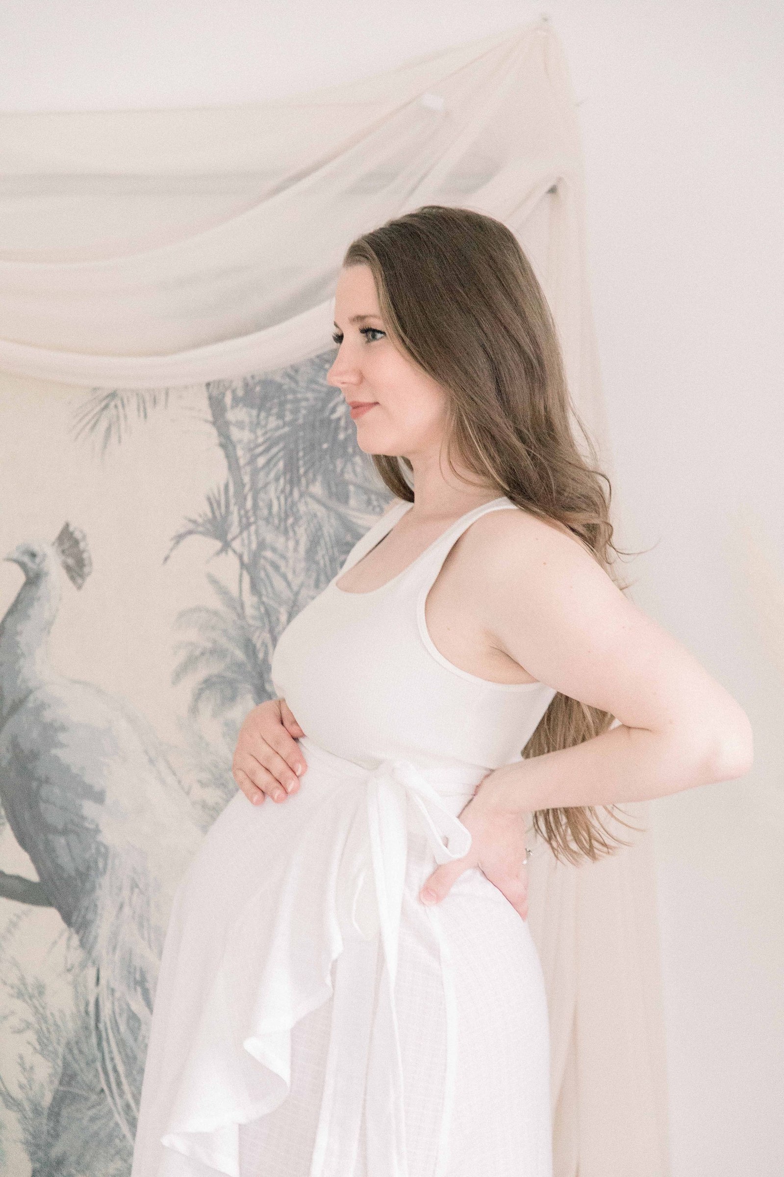 Portrait of a pregnant women holding her belly and in a studio. Portrait photography, family photography, motherhood photography, Niagara photographer, Niagara family photography, Vankleek Hill family photography. Emily VanderBeek Photography.
