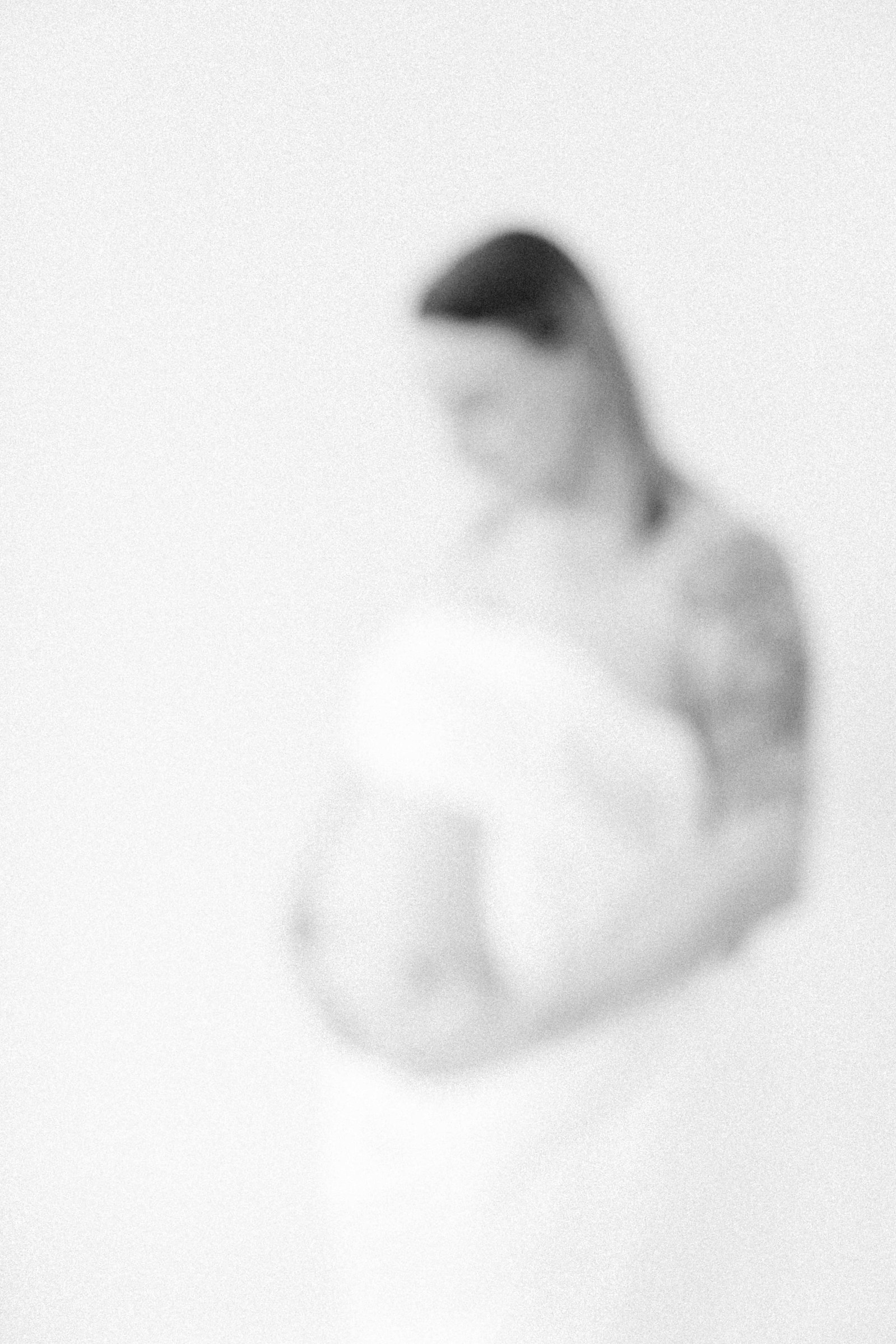 Black and white studio portrait of a pregnant mother. Ottawa Maternity Photographer, Montreal Maternity Photographer, Motherhood Photography, Authentic Photography, Light & Airy Photography, Emily VanderBeek Photography.