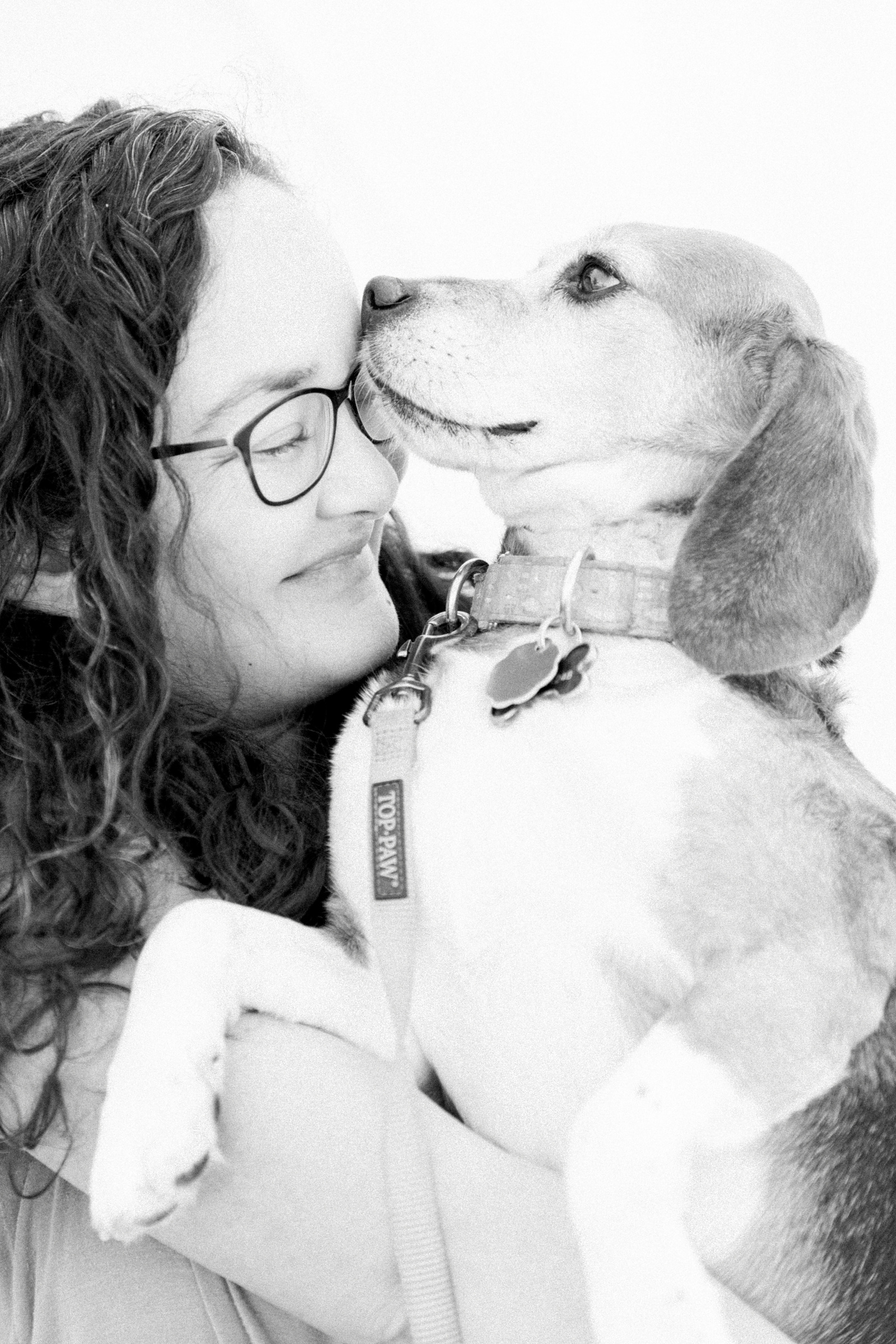 Black & white, light & airy photo of a woman holding her beagle. Emily VanderBeek Photography, Niagara portrait photographer, Niagara family photographer, candid photography, authentic photography, Ottawa portrait photographer, pet photography.