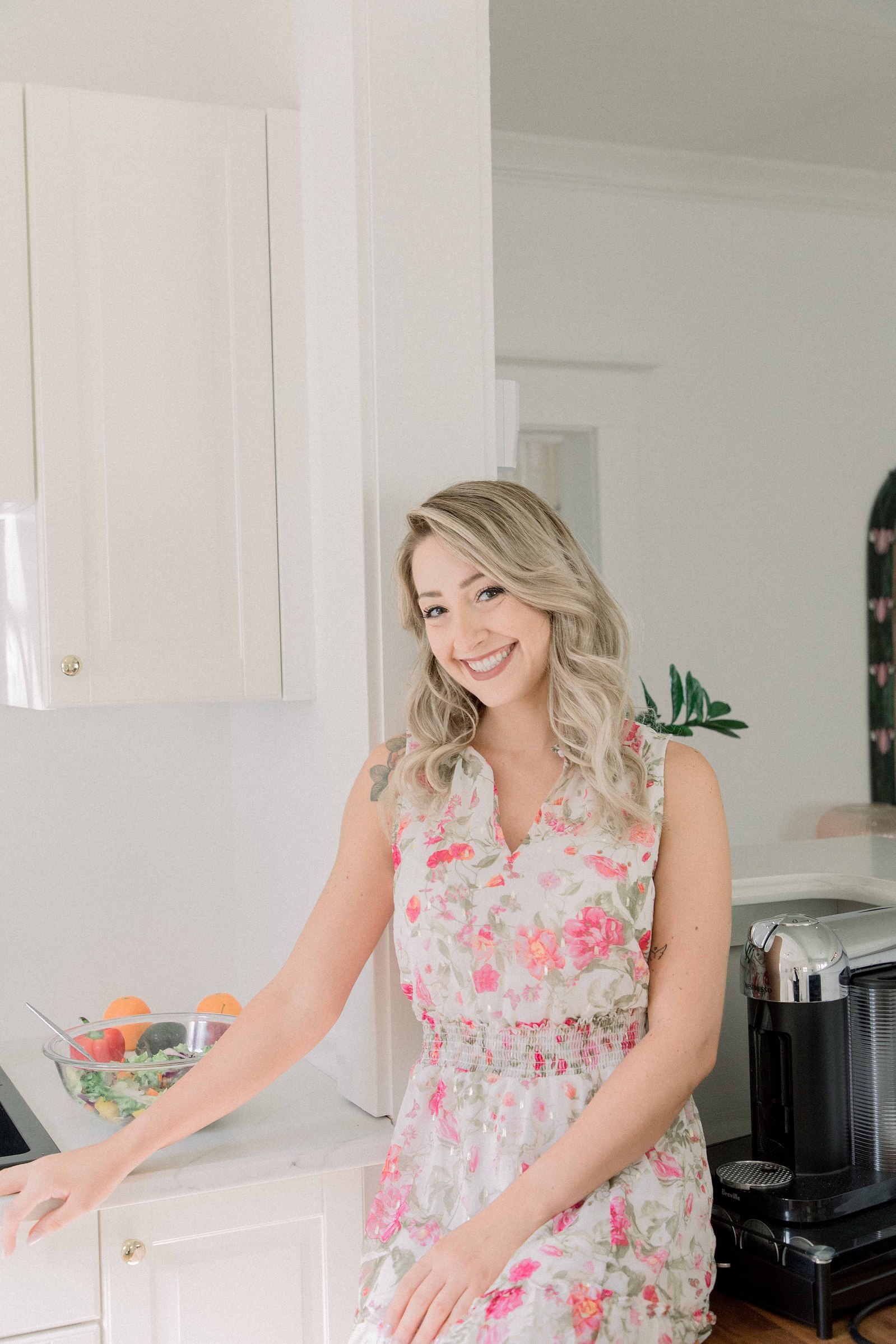 Portrait of a woman sitting on the counter of a studio kitchen. Light and airy photography. Emily VanderBeek Photography. Niagara Photographer, Ottawa Photographer, Montreal Photographer.