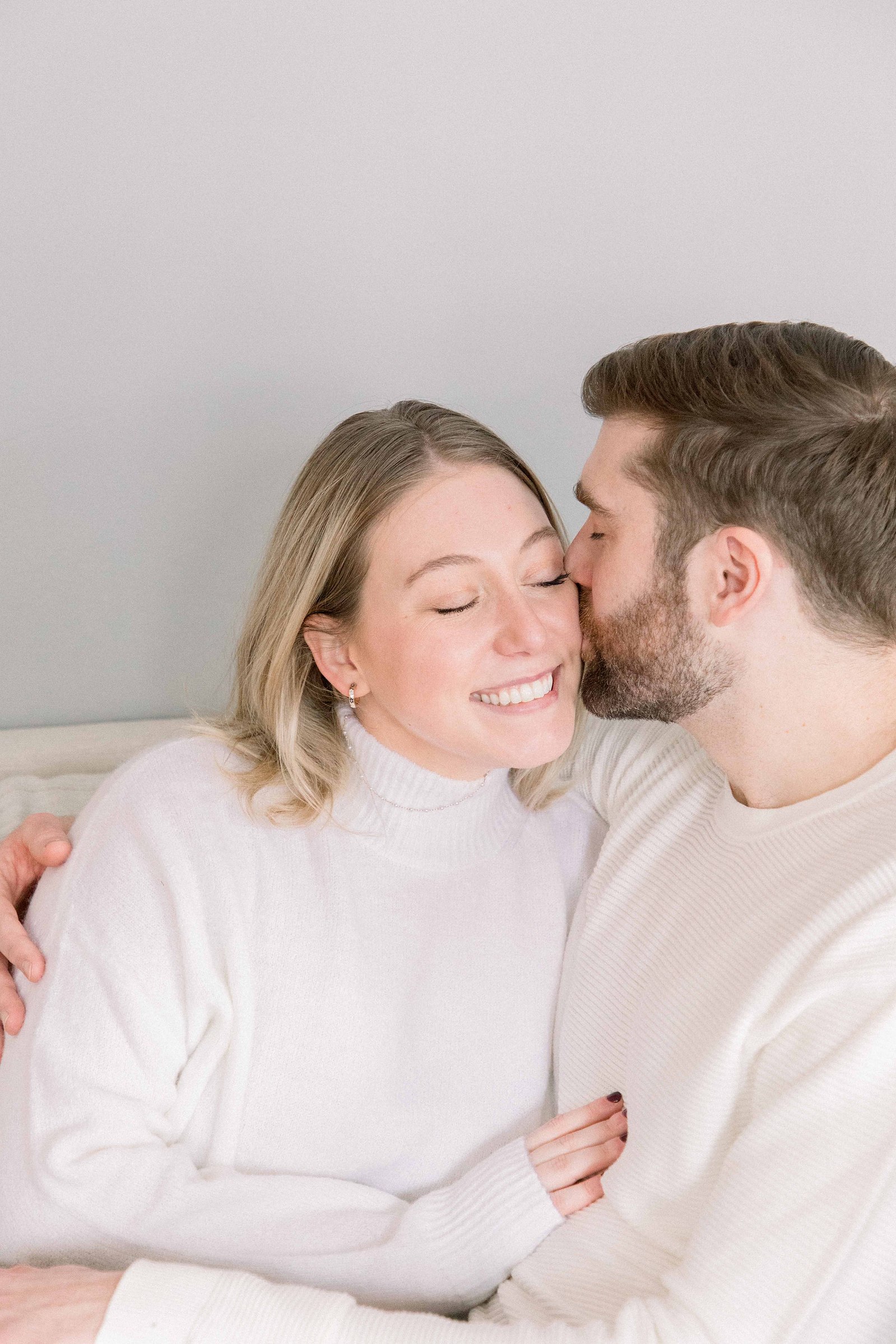 Cozy portrait of male & female couple  inside their home. Christmas Photos. Ottawa Photographer. Vankleek Hill Photographer. Champlain Photographer. Emily VanderBeek Photography. Candid photography.