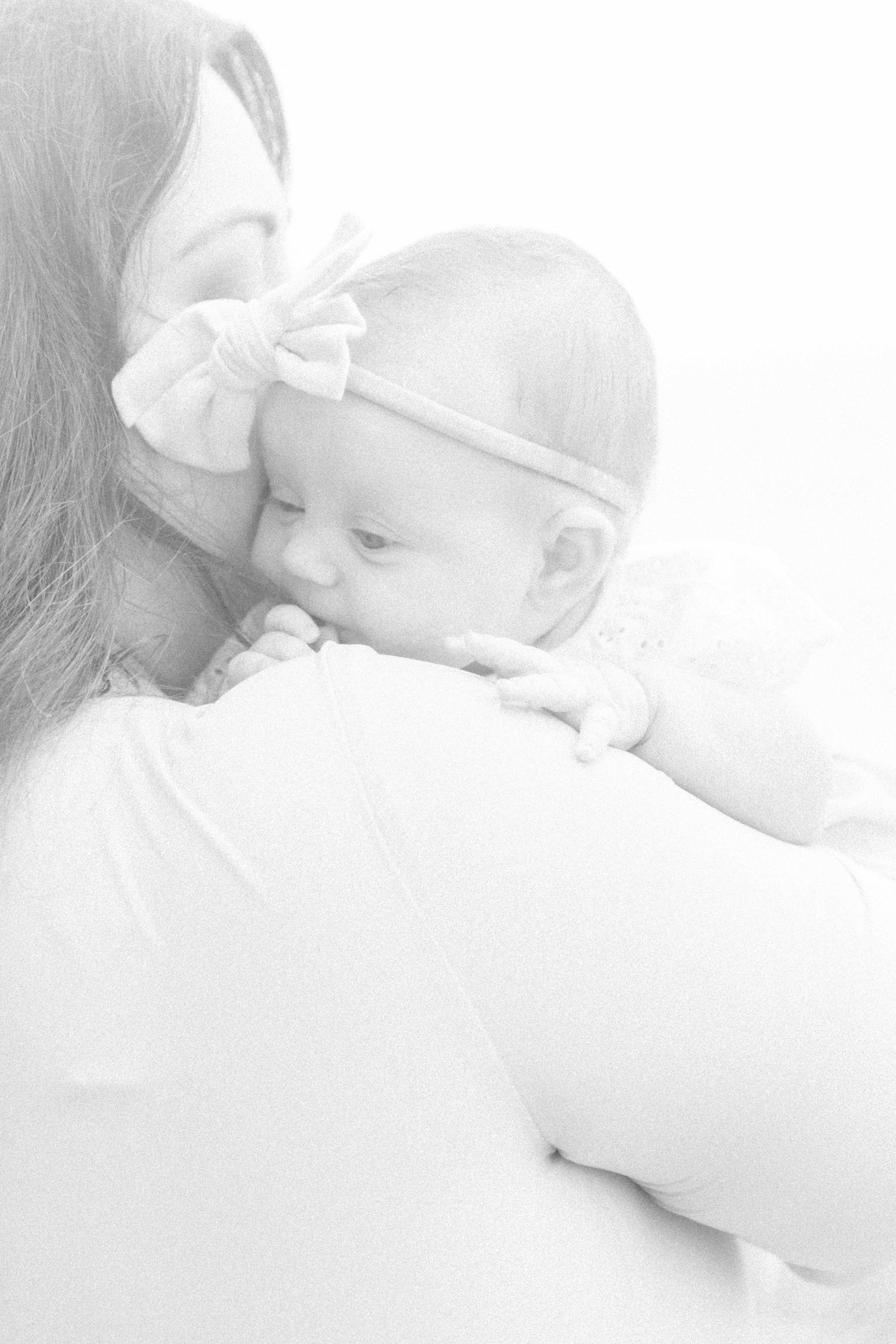 Black and white portrait of mother holding her baby girl on the beach, Niagara Portrait Photographer, Niagara Family Photographer, Niagara Motherhood Photography, Beach Portrait Photography, Emily VanderBeek Photography.