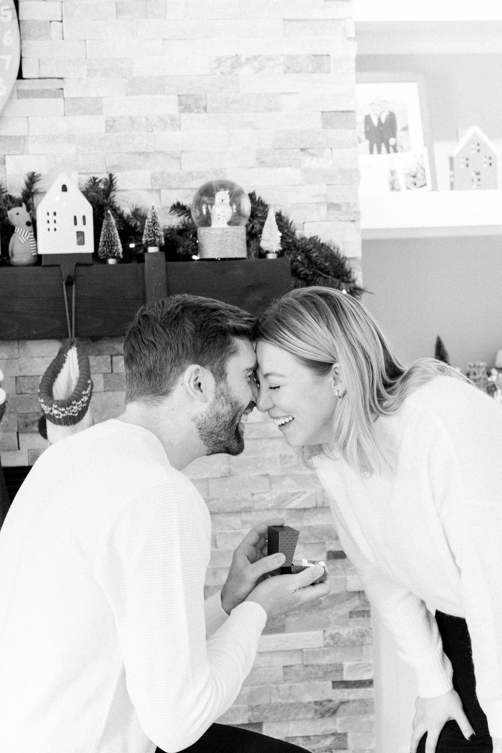 Cozy portrait of male & female couple inside their home. Surprise Proposal. Proposing. Christmas Photos. Ottawa Photographer. Vankleek Hill Photographer. Champlain Photographer. Emily VanderBeek Photography. Candid photography.