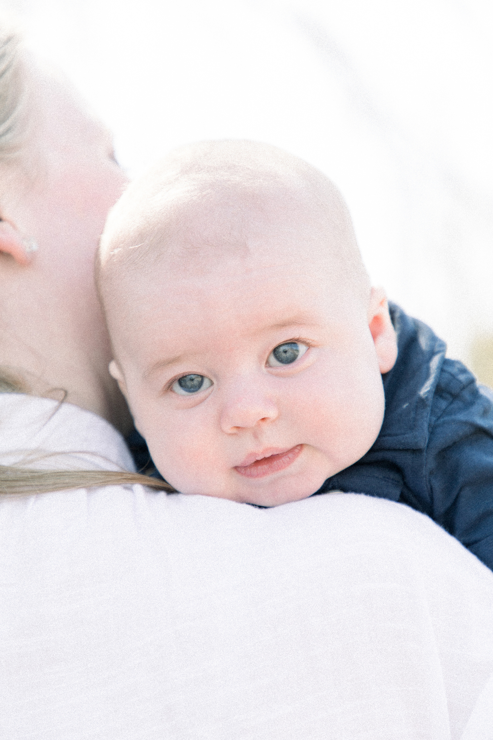 Close up portrait of baby boy being held by his mother, Niagara portrait photographer, Niagara family photographer, family photography, candid photography.