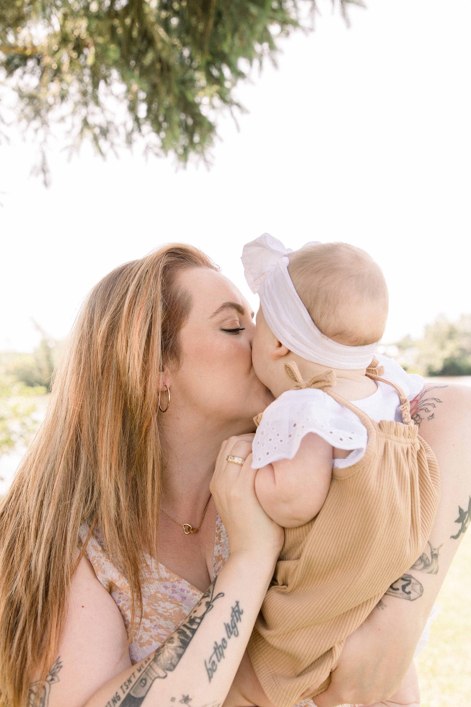 Candid portrait of a mom and baby girl in front of the Ottawa River in Hawkesbury, Portrait Photographer, Family Photographer, Emily VanderBeek Photography, Candid Photography, making memories.