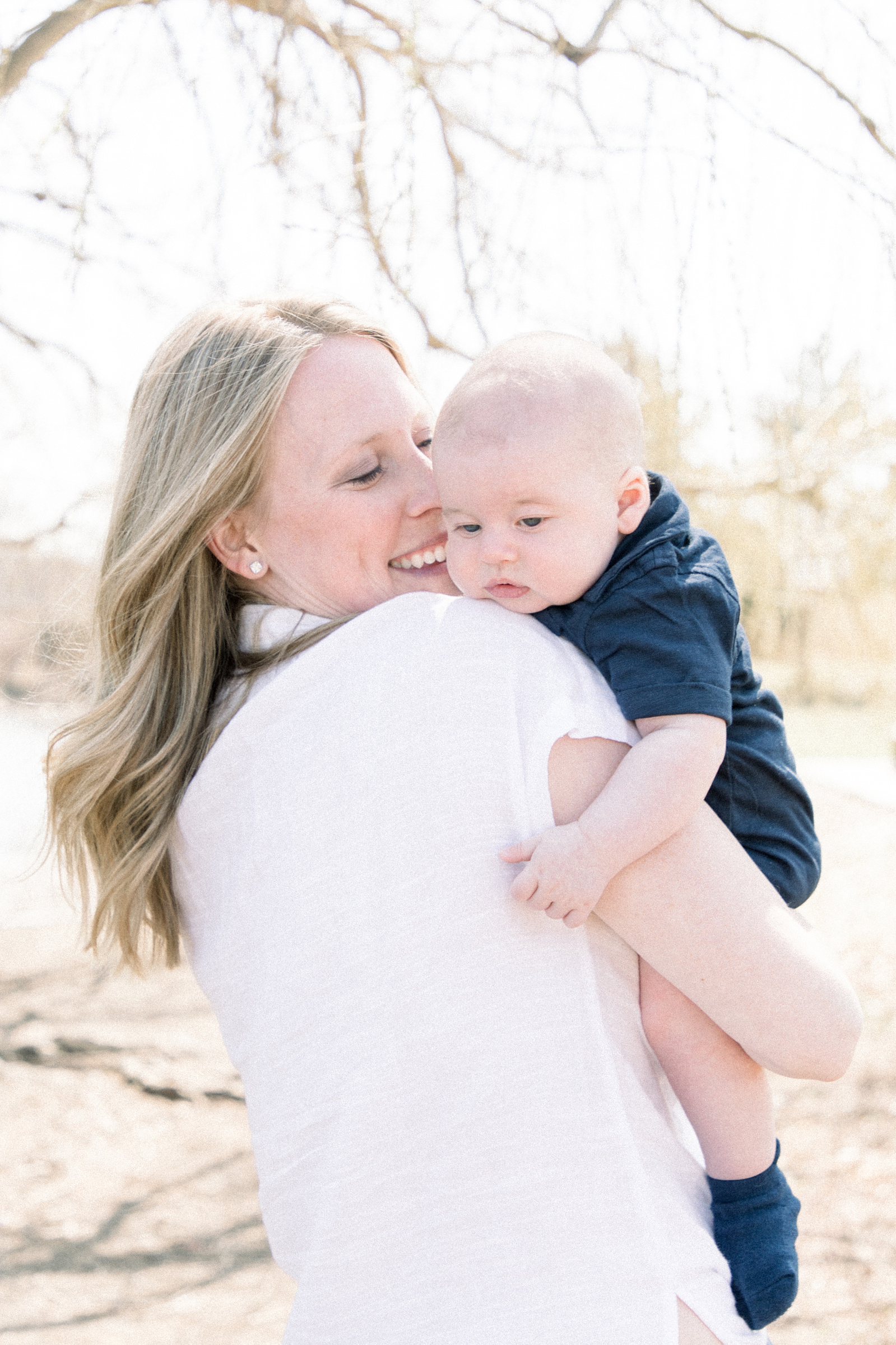 Portrait of mother holding her baby boy, Niagara portrait photographer, Niagara family photographer, family photography, candid photography.