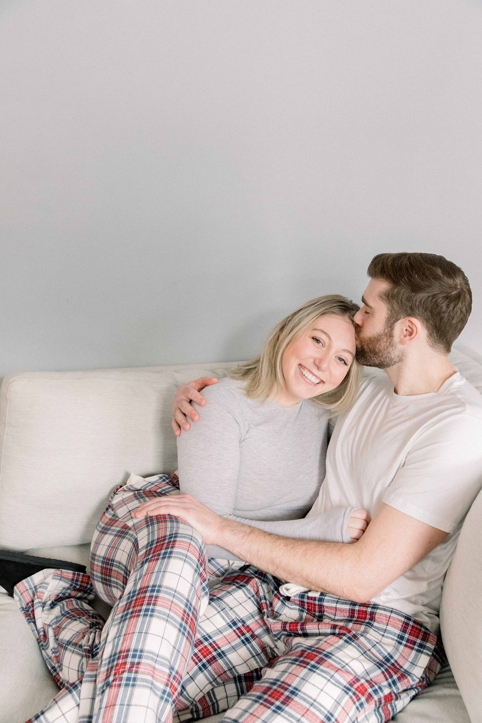 Cozy portrait of male & female couple with their pyjamas on inside their home. Christmas Photos. Ottawa Photographer. Vankleek Hill Photographer. Champlain Photographer. Emily VanderBeek Photography. Candid photography.