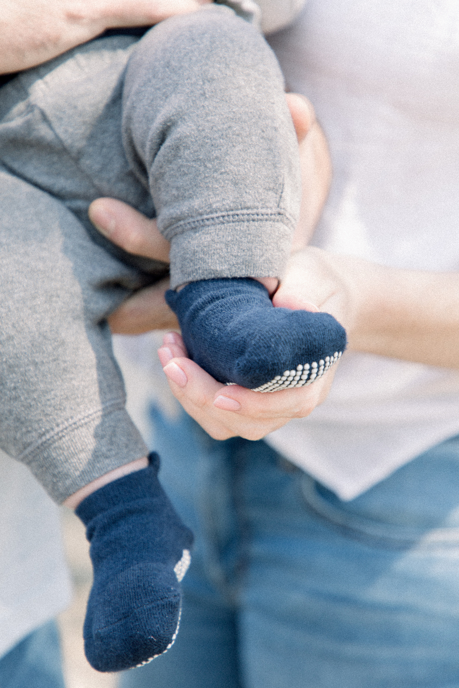 Detail portrait of mother holding her baby boy's feet, Niagara portrait photographer, Niagara family photographer, family photography, candid photography, candid photography.