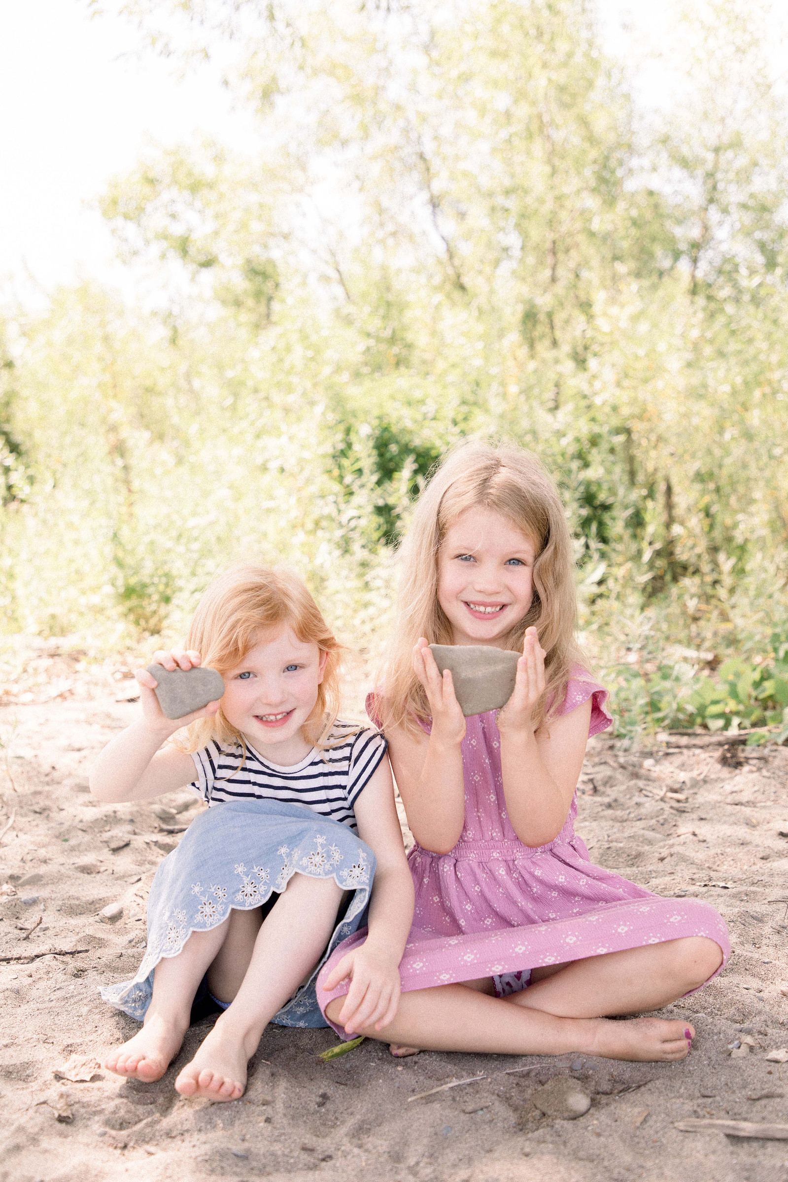 Portrait of two young girls playing on the beach. Niagara family photographer, Niagara portrait photographer, Niagara motherhood photographer, candid photography, light & airy photography, Emily VanderBeek Photography.