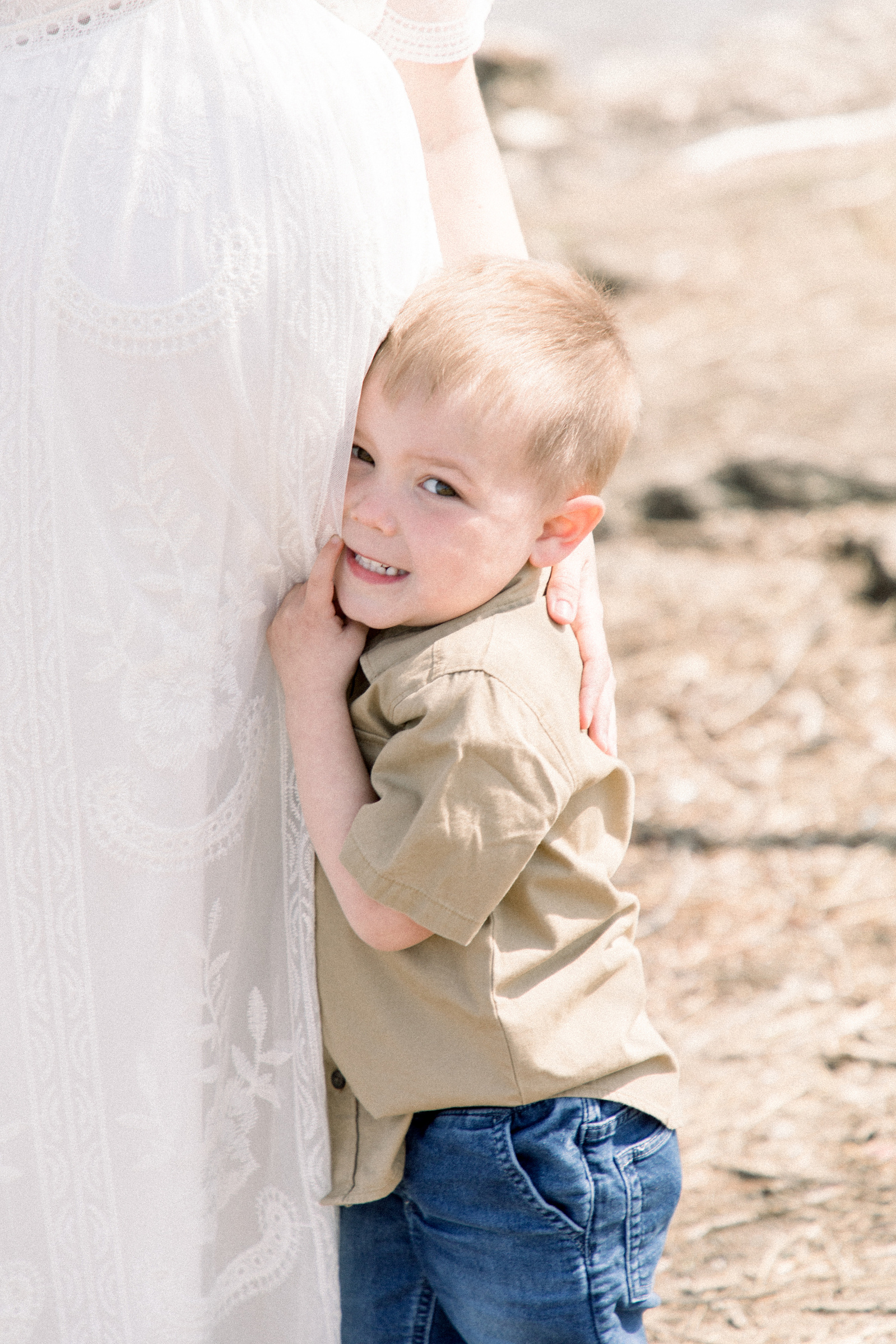 Portrait of a little boy hugging his mother's pregnant belly, Niagara maternity photography, Niagara family photography, park photo session