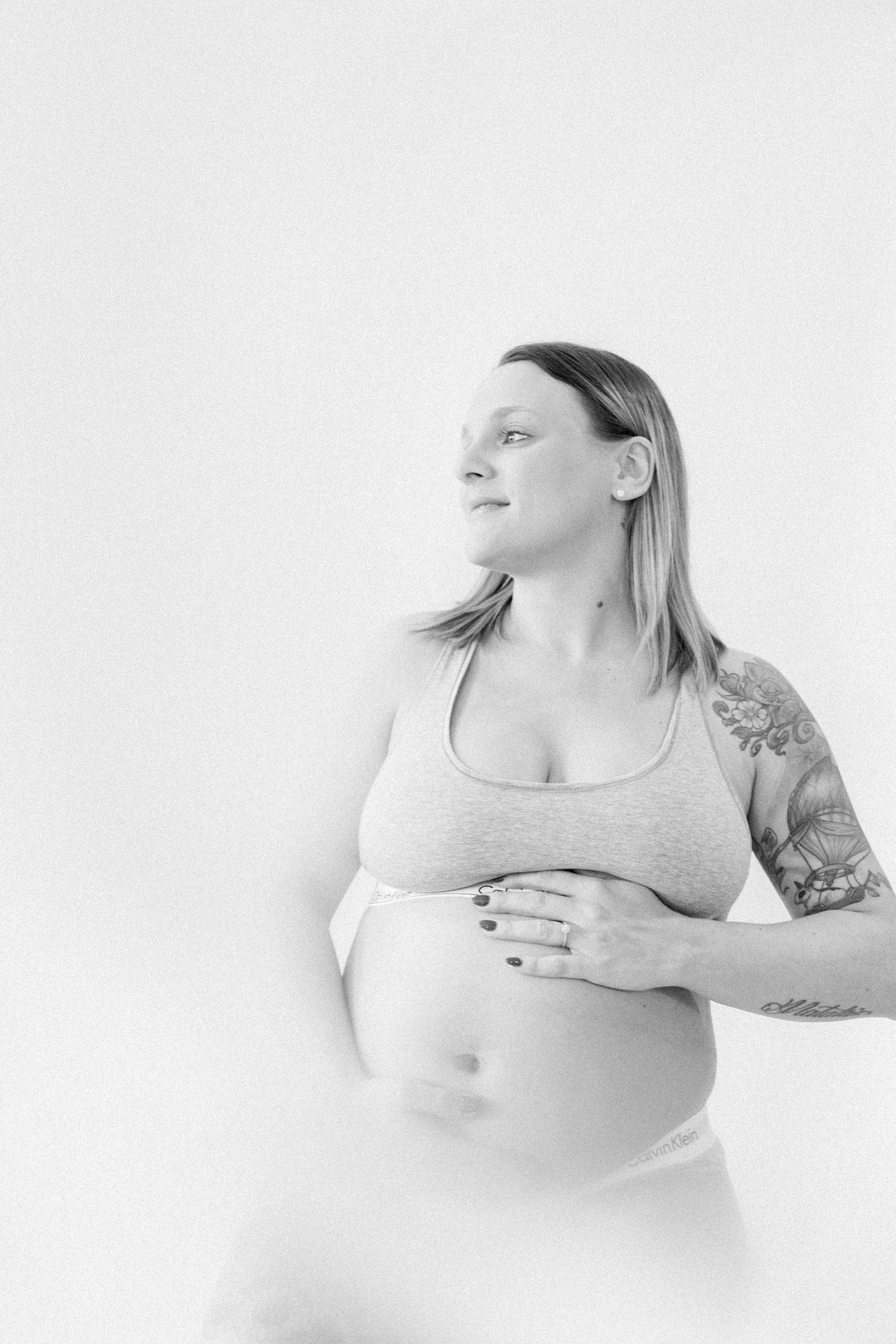 Black and white studio portrait of a pregnant mother. Ottawa Maternity Photographer, Montreal Maternity Photographer, Motherhood Photography, Authentic Photography, Light & Airy Photography, Emily VanderBeek Photography.