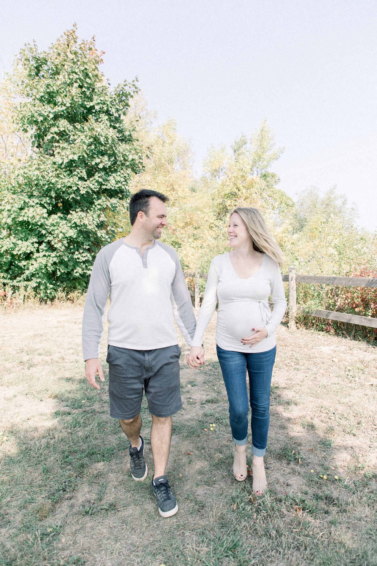 Portrait of husband and expecting wife walking together, Niagara portrait photographer, Niagara family photographer, Niagara maternity photographer, maternity photography, candid photography, candid photography.