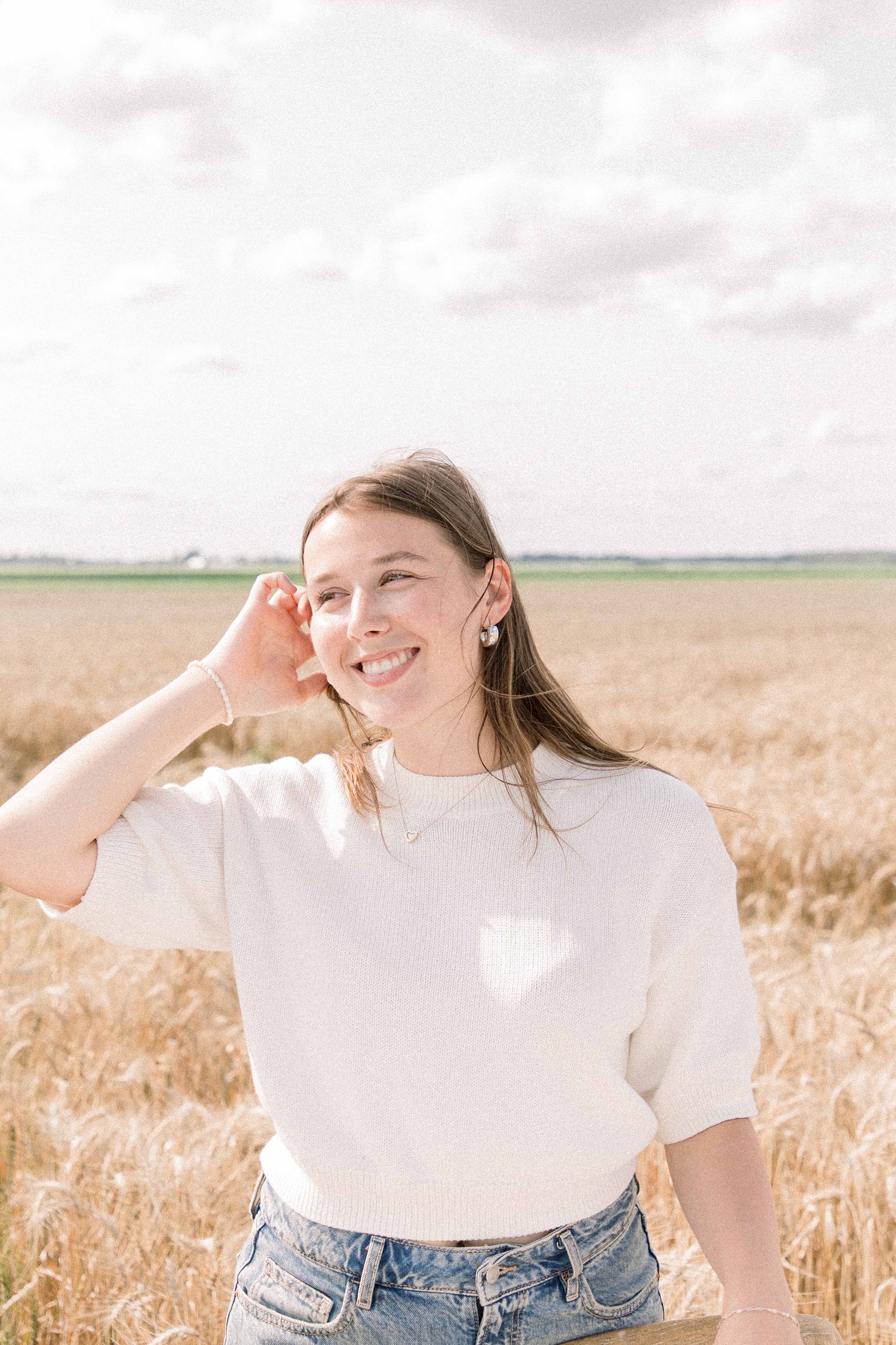 Portrait of a woman in a wheat field in Rigaud, Quebec. Emily VanderBeek Photography. Montreal Photographer. Light & Airy photographer.