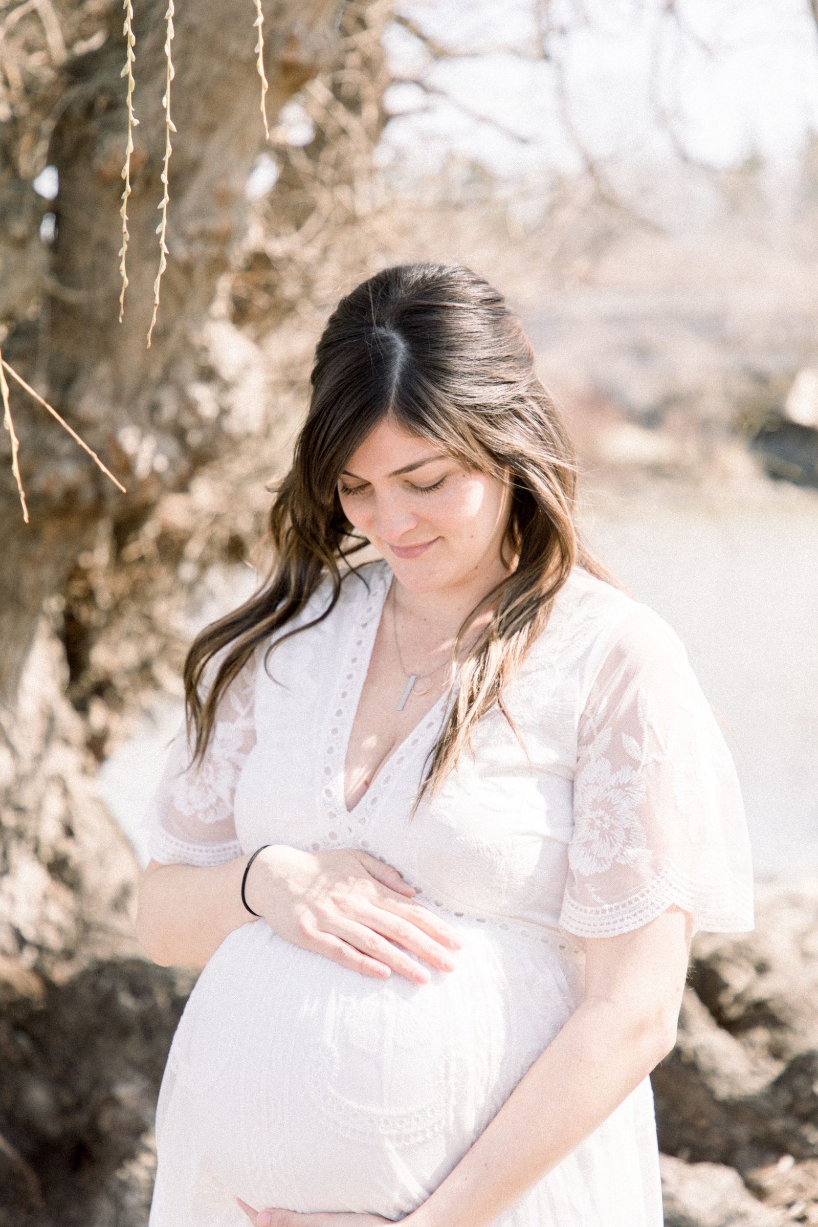 Portrait of an expecting mother holding her belly, Niagara maternity photography, park photo session