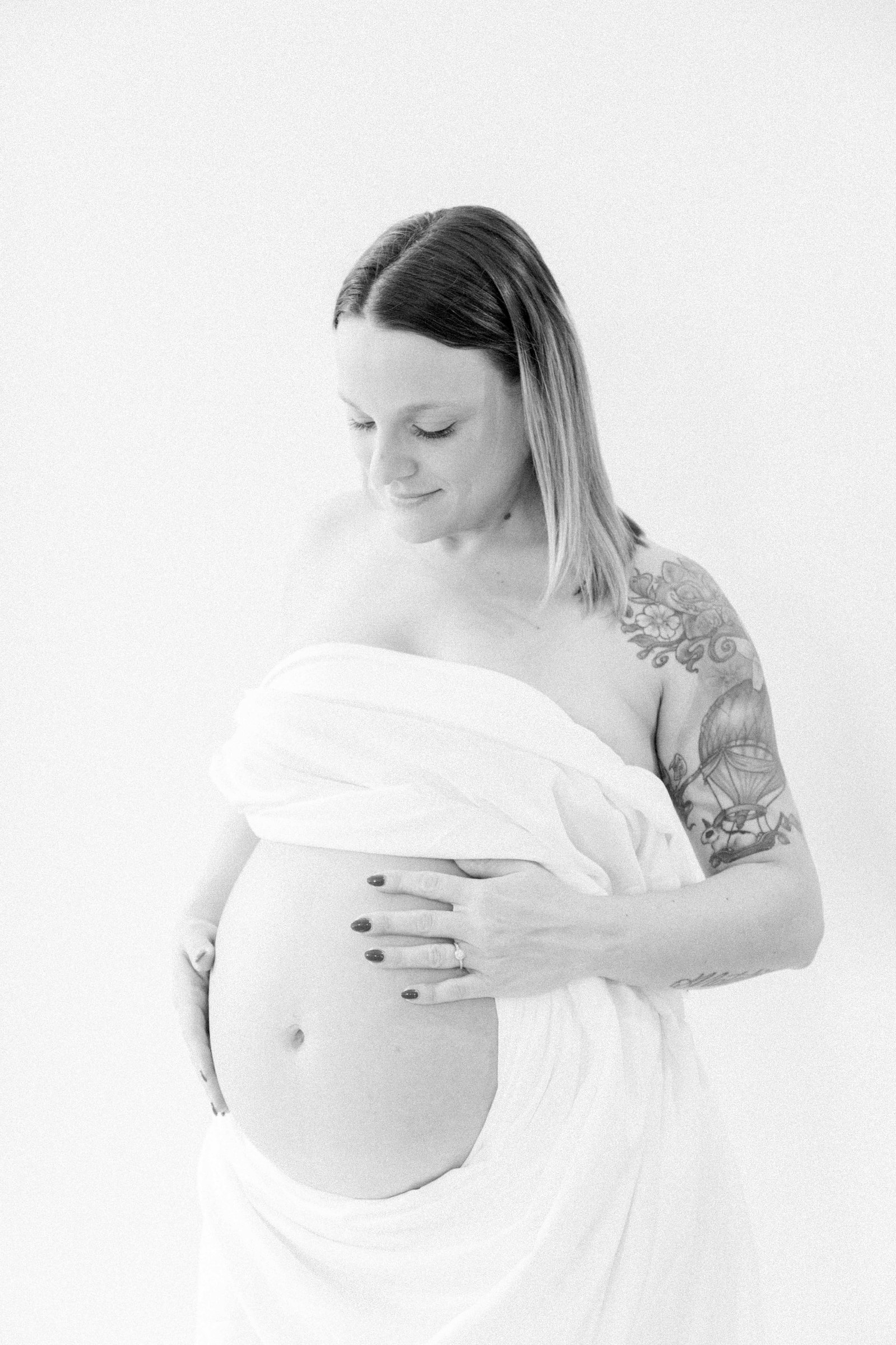 Black and white studio portrait of a pregnant mother. Ottawa Maternity Photographer, Montreal Maternity Photographer, Motherhood Photography, Authentic Photography, Light & Airy Photography, Emily VanderBeek Photography.