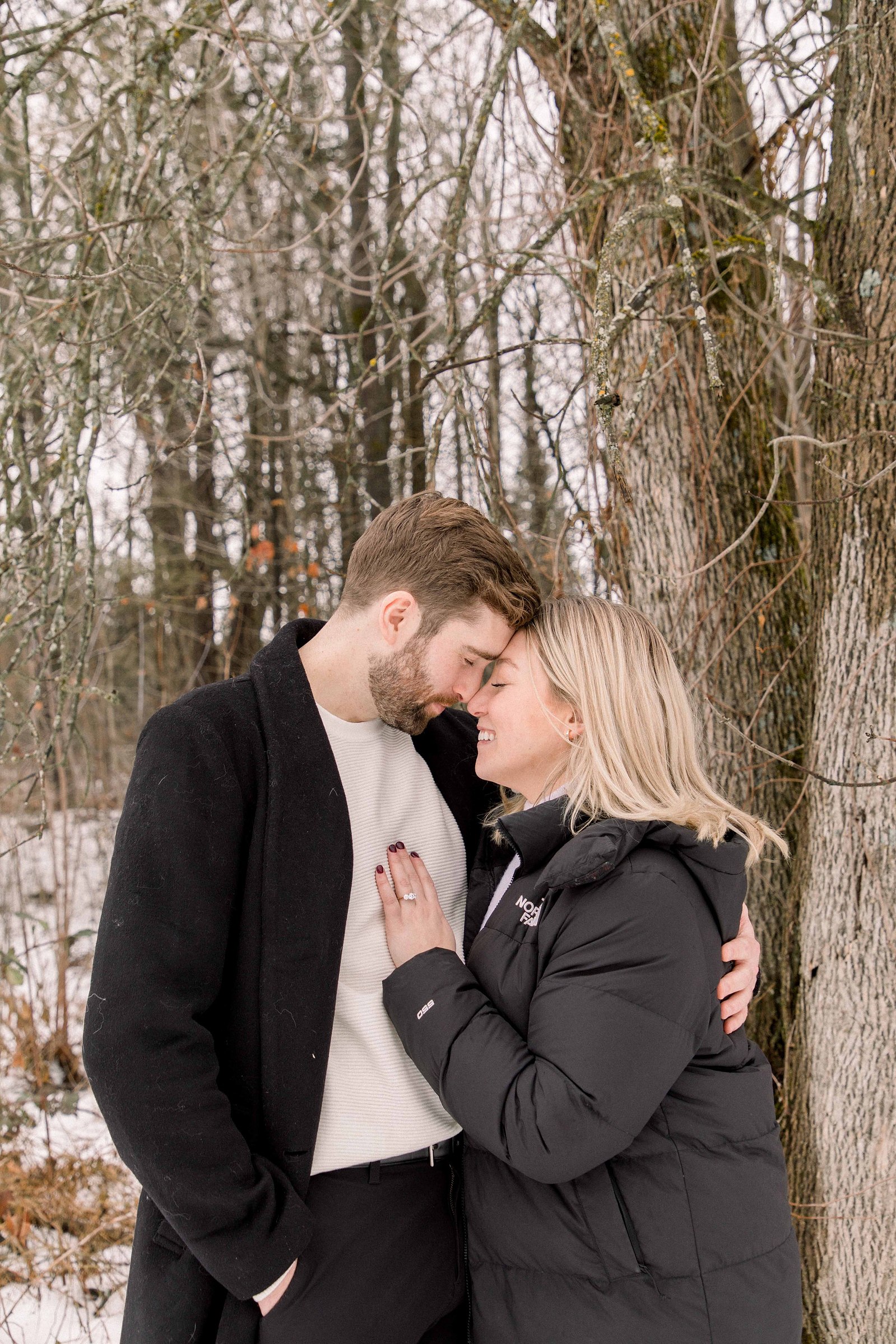 Outdoor Portrait of couple, touching foreheads together. Surprise Proposal. Proposing. Christmas Photos. Ottawa Photographer. Vankleek Hill Photographer. Champlain Photographer. Emily VanderBeek Photography. Candid photography.