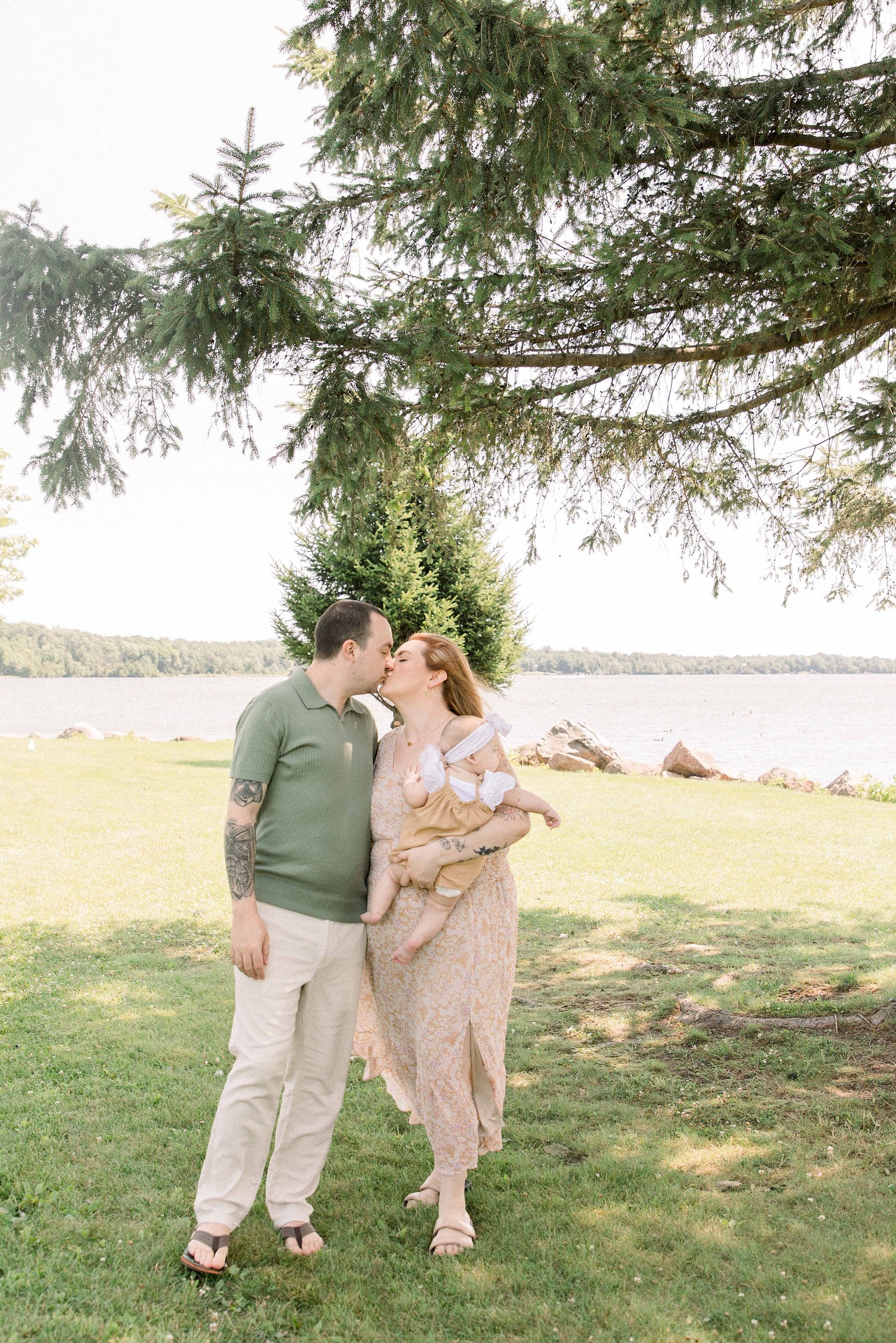 Portrait of a family of three in front of Ottawa River in Hawkesbury, Portrait Photographer, Family Photographer, Emily VanderBeek Photography, Candid Photography, making memories.