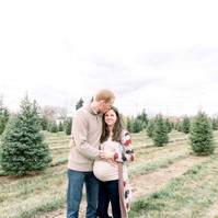 Maternity photo of man hugging woman on Christmas tree farm, Emily VanderBeek Photography, Portrait and Family photography, Niagara Photographer, Champlain Photographer, Vaudreuil-Soulanges Photographer, candid photography, authentic photography.