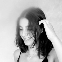 Black and white portrait of a women looking down and smiling, Emily VanderBeek Photography, Portrait and Family photography, Niagara Photographer, Champlain Photographer, Vaudreuil-Soulanges Photographer, candid photography, authentic photography.