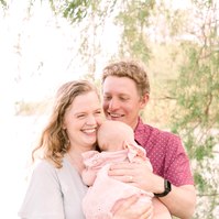 Candid portrait of family of three by the water. Emily VanderBeek Photography, Portrait and Family photography, Niagara Photographer, Champlain Photographer, Vaudreuil-Soulanges Photographer, candid photography, authentic photography.