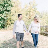 Maternity photo of man and woman walking together looking at bump, Emily VanderBeek Photography, Portrait and Family photography, Niagara Photographer, Champlain Photographer, Vaudreuil-Soulanges Photographer, candid photography, authentic photography.