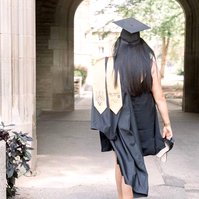 Graduation photo of woman walking away with her sash and gown showing Emily VanderBeek Photography, Portrait and Family photography, Niagara Photographer, Champlain Photographer, Vaudreuil-Soulanges Photographer, candid photography, authentic photography.