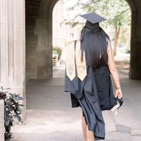 Graduation photo of woman walking away with her sash and gown showing Emily VanderBeek Photography, Portrait and Family photography, Niagara Photographer, Champlain Photographer, Vaudreuil-Soulanges Photographer, candid photography, authentic photography.