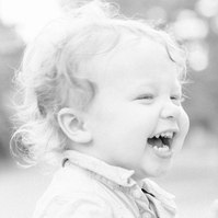 Black and white candid photo of little boy laughing, Emily VanderBeek Photography, Portrait and Family photography, Niagara Photographer, Champlain Photographer, Vaudreuil-Soulanges Photographer, candid photography, authentic photography.