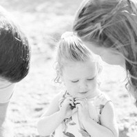 Black and white photo of a family of three on the beach, Emily VanderBeek Photography, Portrait and Family photography, Niagara Photographer, Champlain Photographer, Vaudreuil-Soulanges Photographer, candid photography, authentic photography.