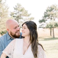 Maternity photo of man and woman looking at each other laughing, Emily VanderBeek Photography, Portrait and Family photography, Niagara Photographer, Champlain Photographer, Vaudreuil-Soulanges Photographer, candid photography, authentic photography.