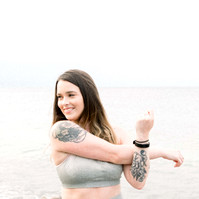 Photo of woman stretching arm muscles in activewear on beach, Emily VanderBeek Photography, Portrait and Family photography, Niagara Photographer, Champlain Photographer, Vaudreuil-Soulanges Photographer, candid photography, authentic photography.