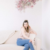Woman sitting on couch in studio smiling into the camera, Emily VanderBeek Photography, Portrait and Family photography, Niagara Photographer, Champlain Photographer, Vaudreuil-Soulanges Photographer, candid photography, authentic photography.