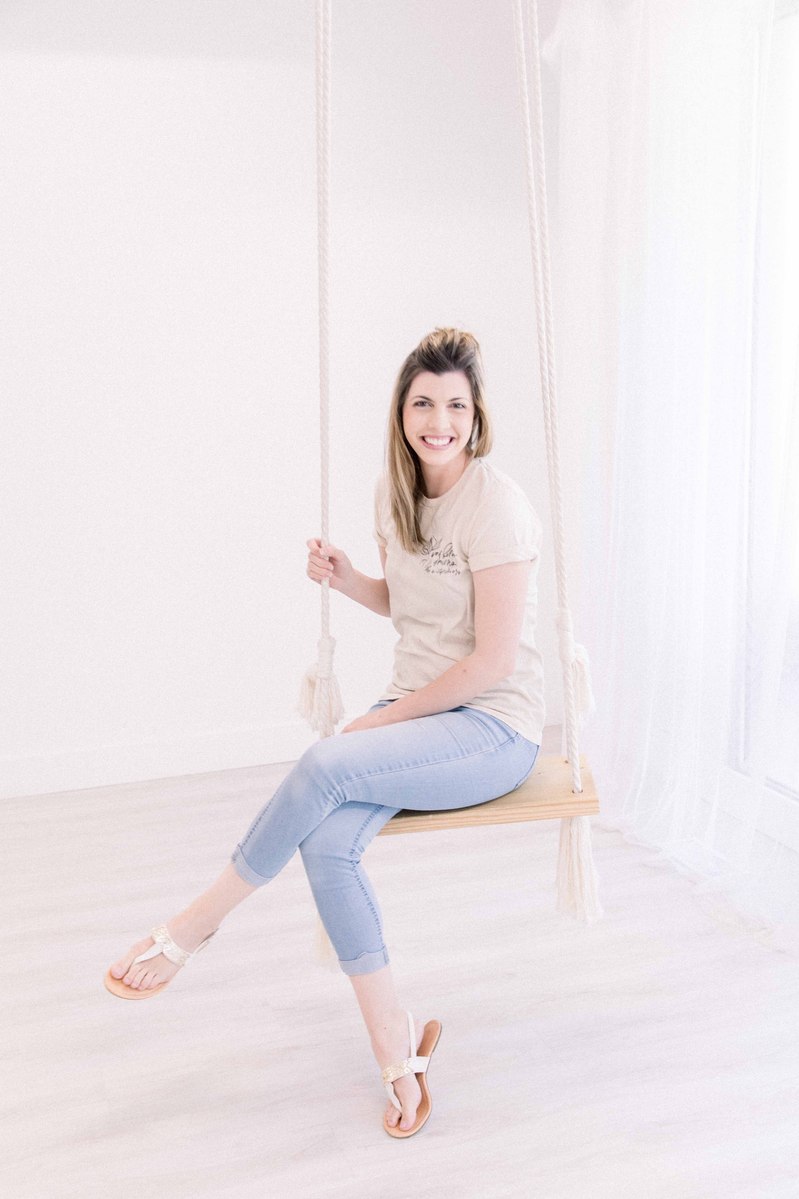 Portrait of woman in studio sitting on swing and smiling, Emily VanderBeek Photography, Portrait and Family photography, Niagara Photographer, Champlain Photographer, Vaudreuil-Soulanges Photographer, candid photography, authentic photography.
