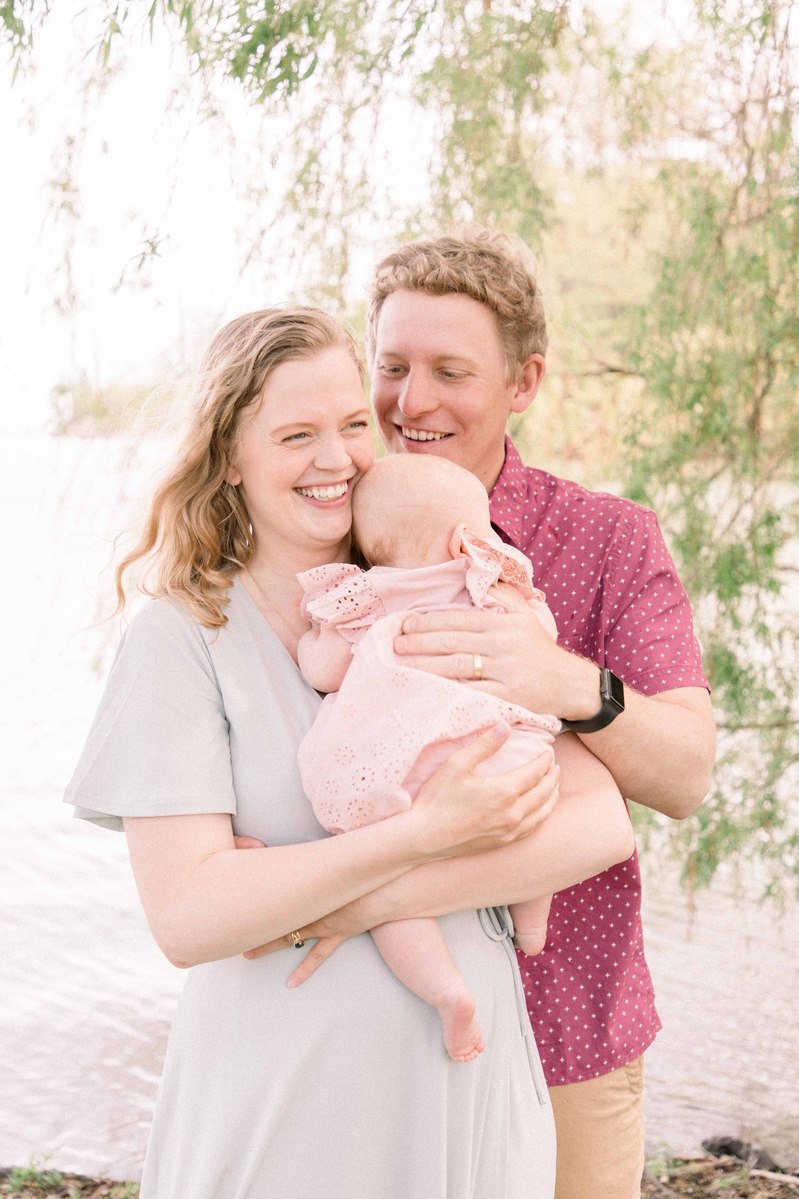 Candid portrait of family of three by the water. Emily VanderBeek Photography, Portrait and Family photography, Niagara Photographer, Champlain Photographer, Vaudreuil-Soulanges Photographer, candid photography, authentic photography.