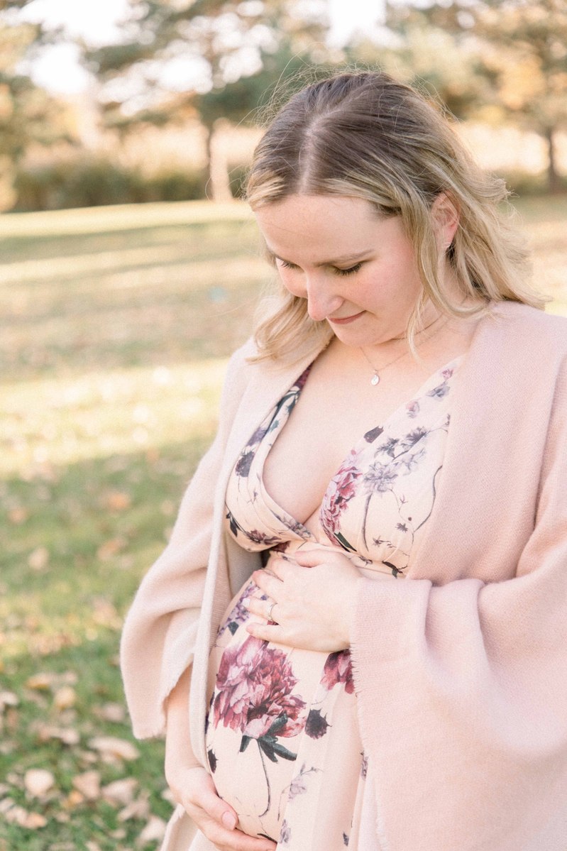 Maternity photo of woman outside at a park looking down at her belly, Emily VanderBeek Photography, Portrait and Family photography, Niagara Photographer, Champlain Photographer, Vaudreuil-Soulanges Photographer, candid photography, authentic photography.
