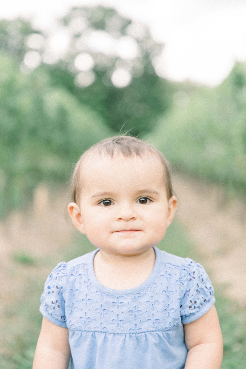 Candid portrait of little girl in a vineyard, Emily VanderBeek Photography, Portrait and Family photography, Niagara Photographer, Champlain Photographer, Vaudreuil-Soulanges Photographer, candid photography, authentic photography.