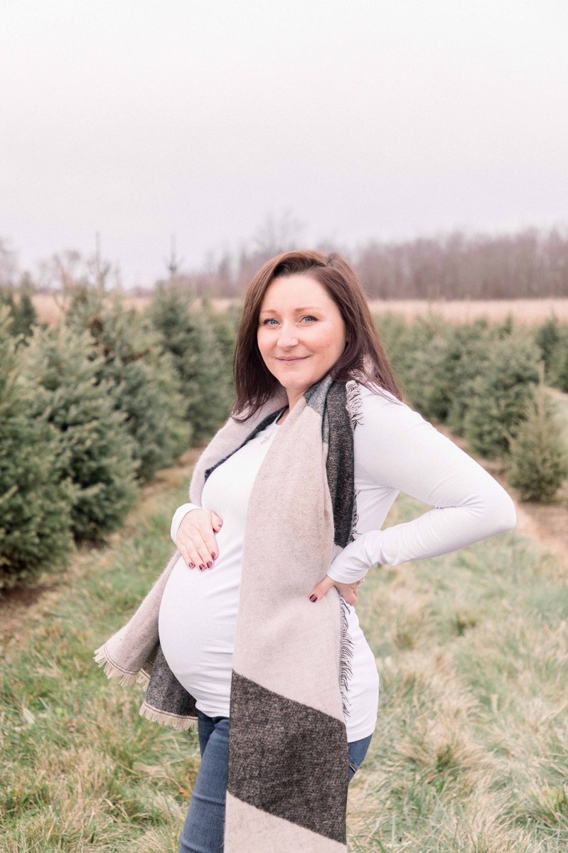 Maternity photo of woman standing on Christmas tree farm, Emily VanderBeek Photography, Portrait and Family photography, Niagara Photographer, Champlain Photographer, Vaudreuil-Soulanges Photographer, candid photography, authentic photography.
