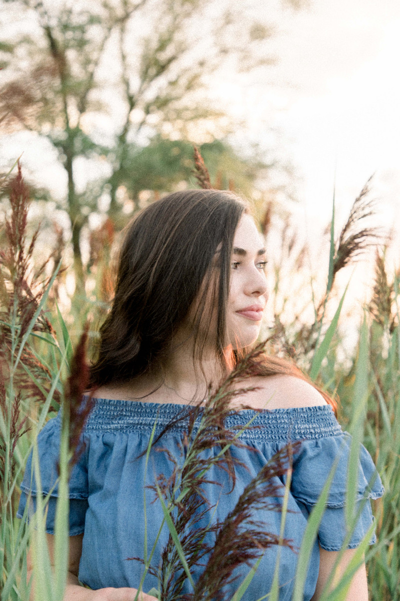 Portrait of woman looking away from camera standing in tall grass, Emily VanderBeek Photography, Portrait and Family photography, Niagara Photographer, Champlain Photographer, Vaudreuil-Soulanges Photographer, candid photography, authentic photography.