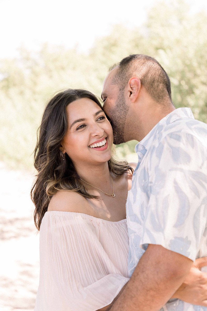 Portrait of husband kissing wife on the cheek. Emily VanderBeek Photography, Portrait and Family photography, Niagara Photographer, Champlain Photographer, Vaudreuil-Soulanges Photographer, candid photography, authentic photography.