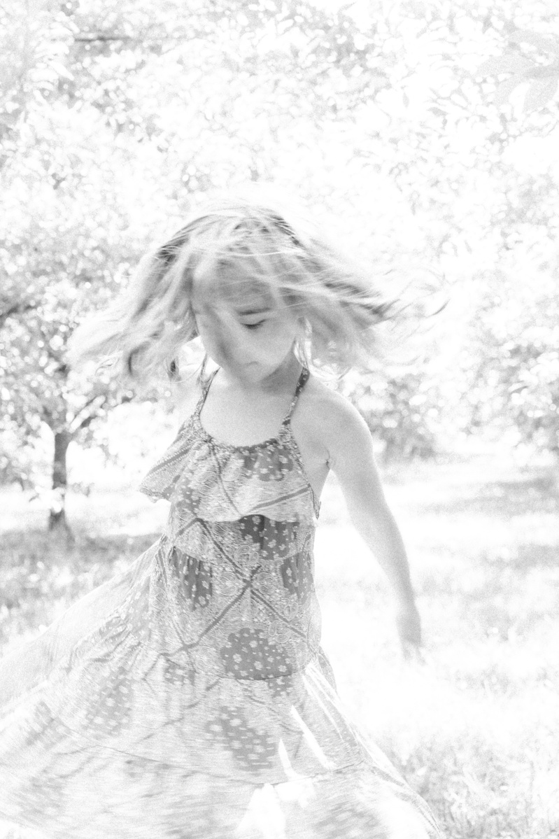 Candid portrait of little girl twirling around an orchard, Emily VanderBeek Photography, Portrait and Family photography, Niagara Photographer, Champlain Photographer, Vaudreuil-Soulanges Photographer, candid photography, authentic photography.