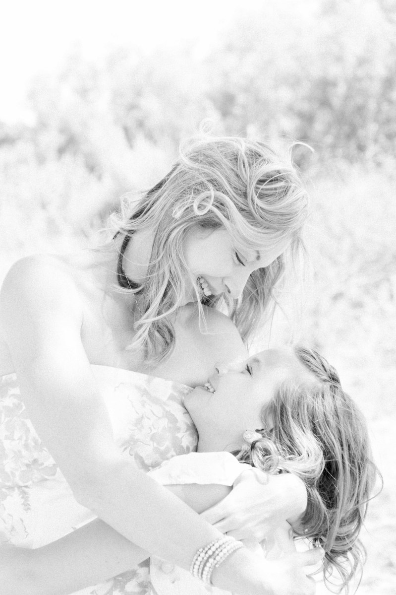 Black and white portrait of mother looking at daughter hugging her, Emily VanderBeek Photography, Portrait and Family photography, Niagara Photographer, Champlain Photographer, Vaudreuil-Soulanges Photographer, candid photography, authentic photography.