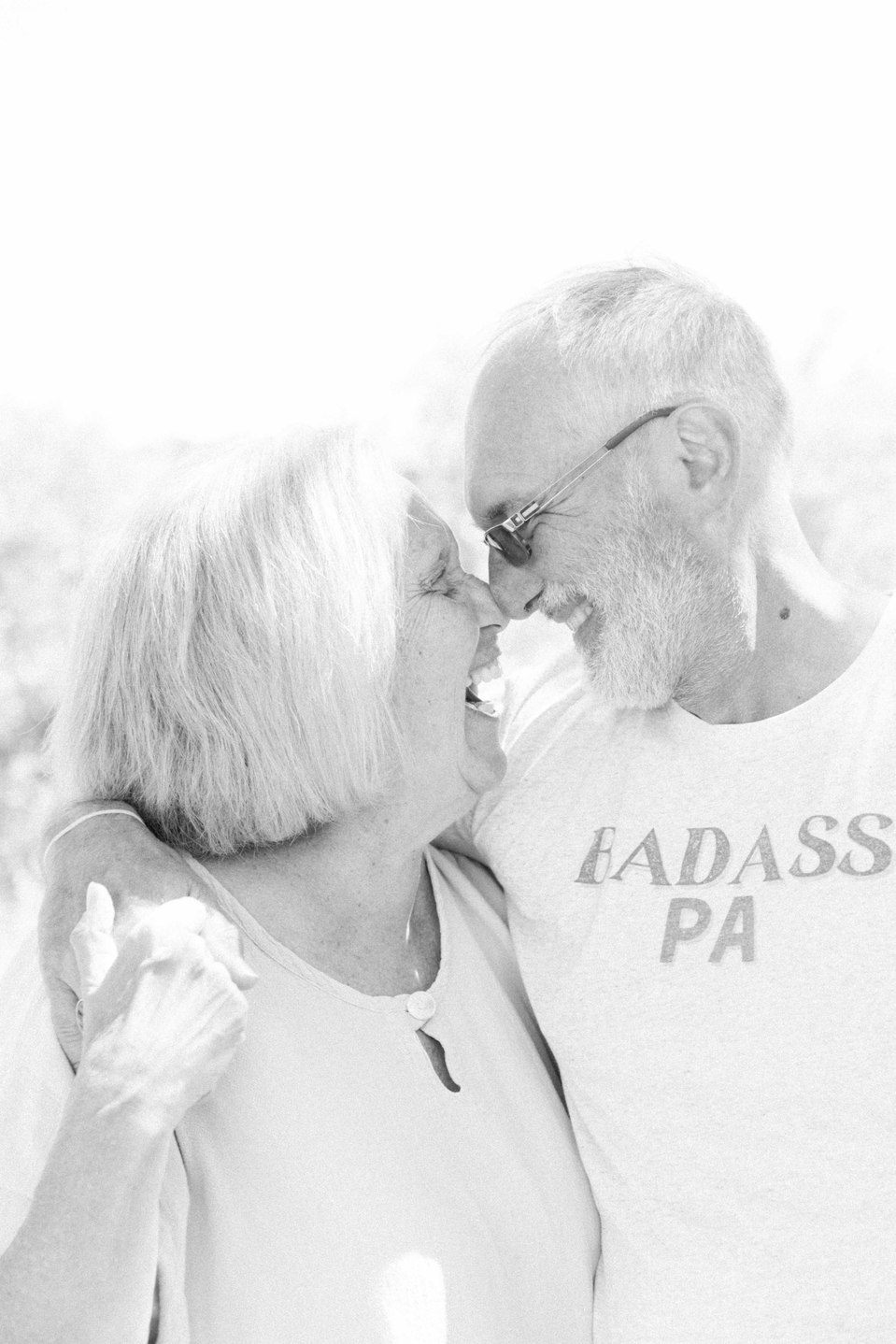 Black & white portrait of husband and wife looking at each other touching noses, Niagara portrait photographer, Niagara family photographer, portrait photography, family photography, candid photography, authentic photography, Emily VanderBeek Photography.