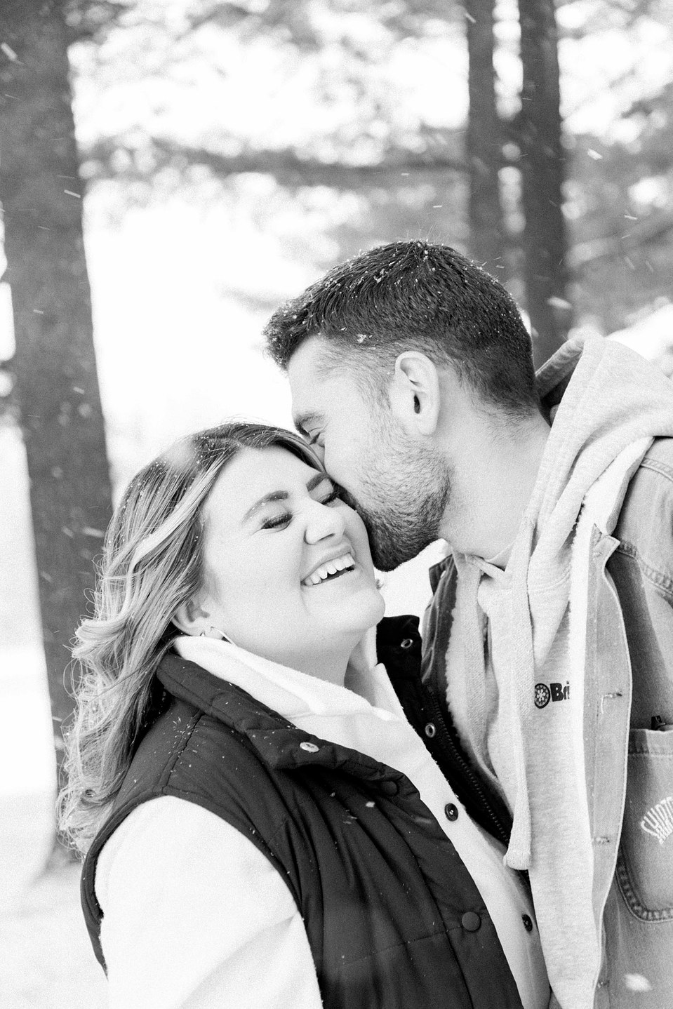 Black & white portrait of young couple  man kissing woman on the cheek, Niagara family photographer, family photography, Niagara portrait photographer, portrait photography, Champlain photographer, Hawkesbury photographer, Emily VanderBeek Photography.