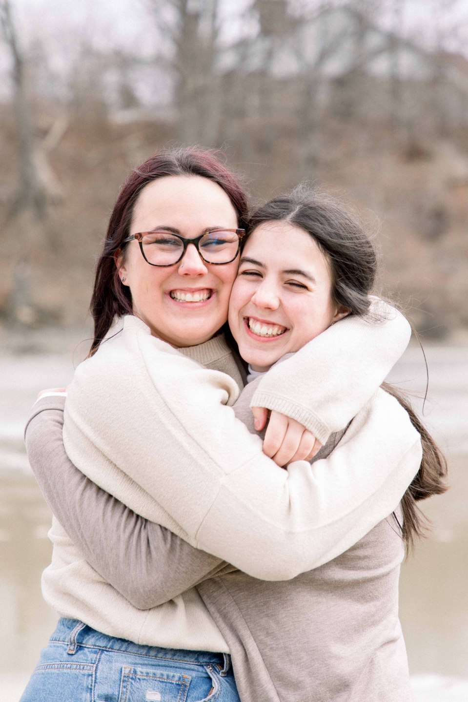 Portrait of two sisters hugging each other and smiling while looking at the camera, Niagara family photographer, family photography, Niagara portrait photographer, portrait photography, Emily VanderBeek Photography.