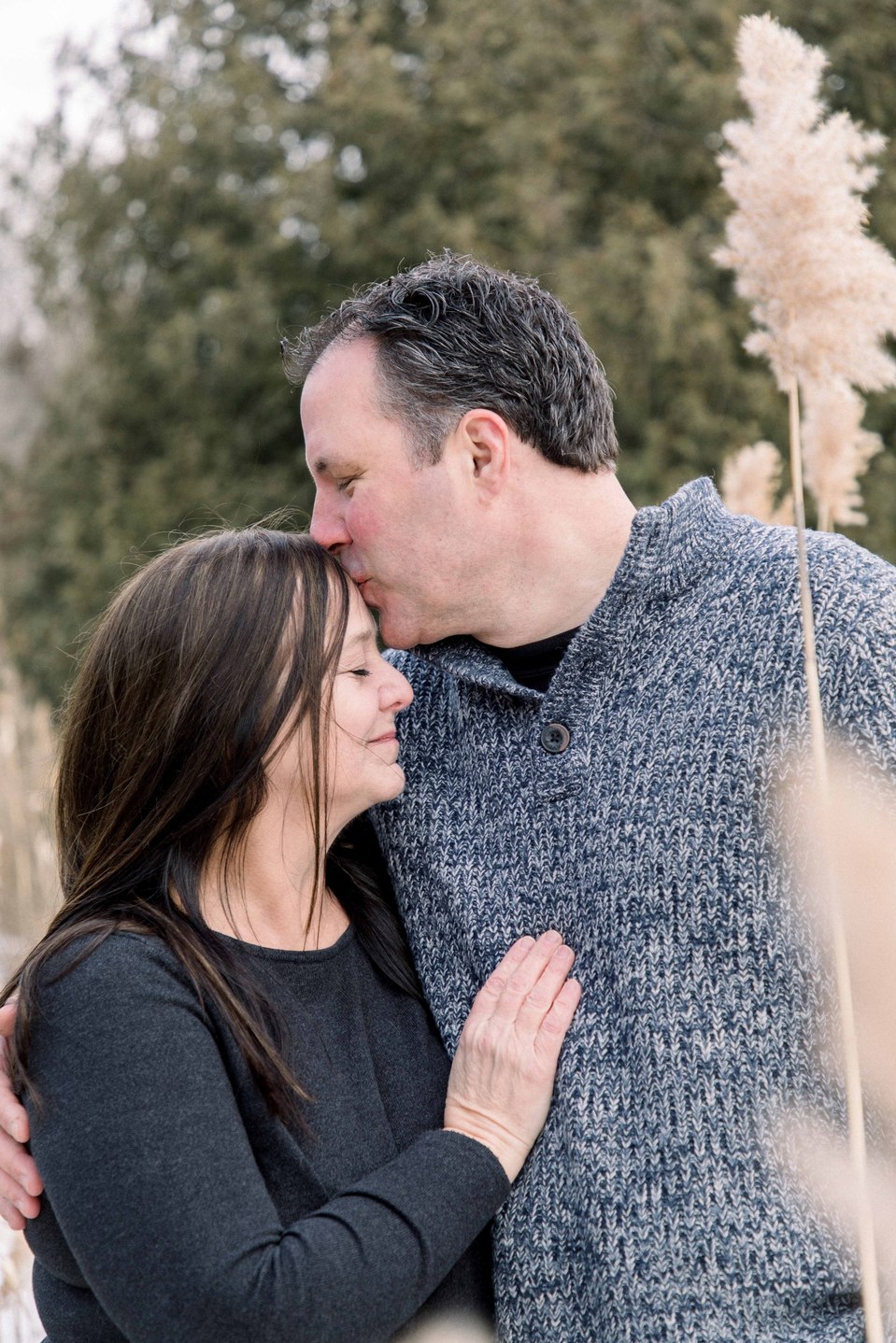 Portrait of husband and wife, husband kissing wife on forehead, Niagara family photographer, family photography, Niagara portrait photographer, portrait photography, Emily VanderBeek Photography.