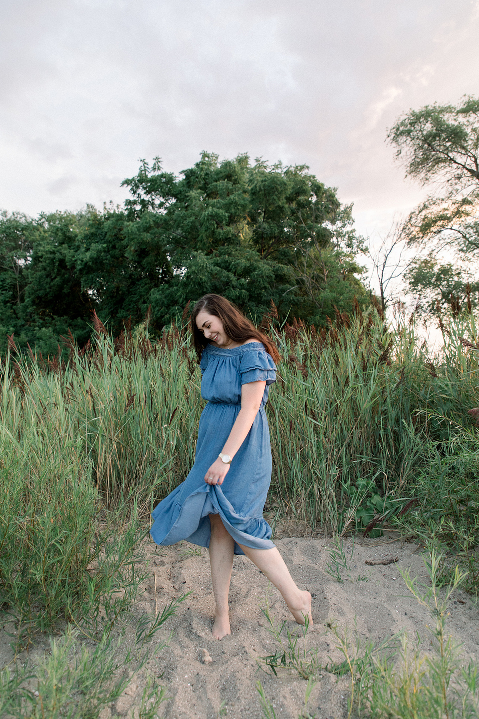 Full portrait of woman playing with her dress, spinning around on the beach. Niagara portrait photography, Niagara portrait photographer, Niagara branding photography, Niagara branding photographer.